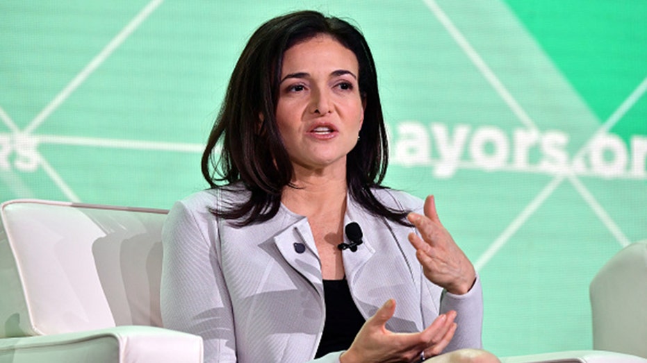 Sheryl Sandberg speaking at a event while sitting down