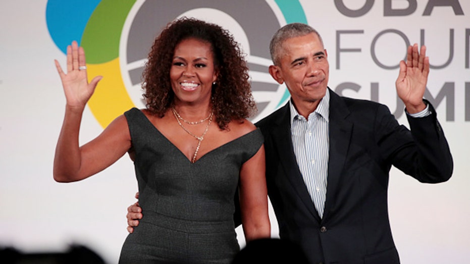 Barack and Michelle Obama waving