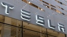 LOS ANGELES, CA - APRIL 10: A Tesla corporate logo hangs on the front of their store in Santa Monica on April 10, 2023, in Los Angeles, California. 