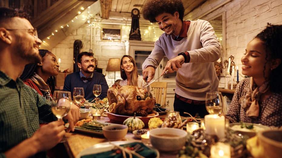 man carving turkey