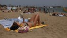 A person reads a book on the Somorrostro Beach in Barcelona, Spain on June 19, 2024. 