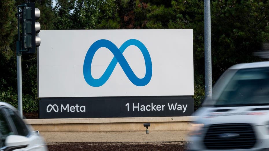 Meta headquarters sign with cars passing