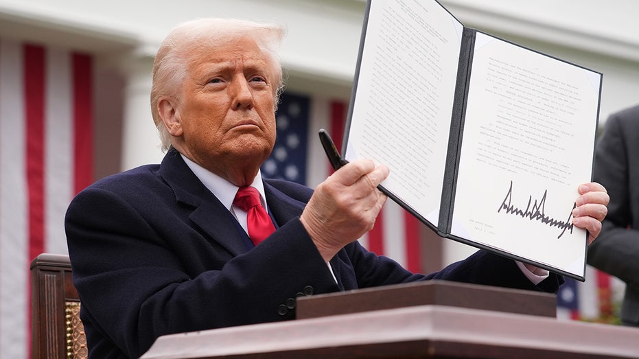 President Donald Trump signs tariffs