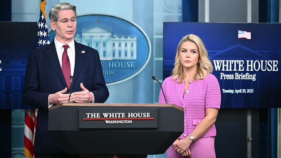 US Secretary of Treasury Scott Bessent speaks as White House Press Secretary Karoline Leavitt looks on during the daily briefing in the Brady Briefing Room of the White House in Washington, DC, on April 29, 2025. (Photo by Mandel NGAN / AFP) (Photo by MANDEL NGAN/AFP via Getty Images)