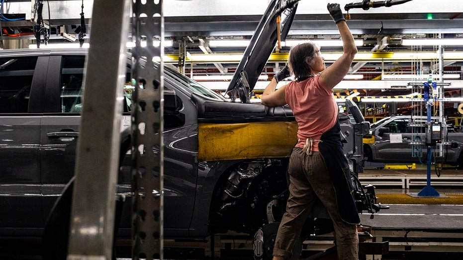 A worker working on General Motors assembly line