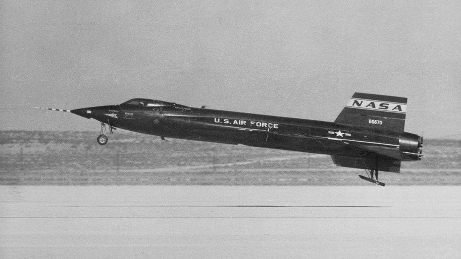 The sleek black NASA X-15 comes in for a smooth landing at a dry lake bed in the Mojave desert after completing a 10-minute flight to establish a new world's speed record of 2150 miles-per-hour. The experimental ship was under the control of Joe Walker, test pilot for NASA.