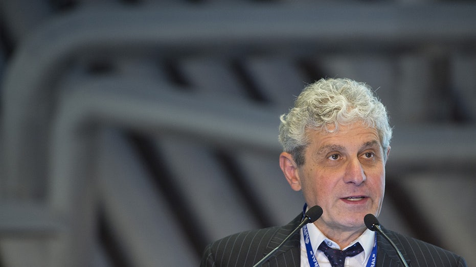 Michael Polsky speaking into microphone