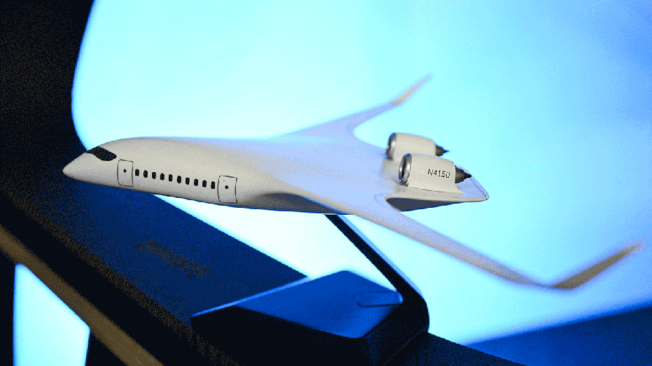 A small scale model of the JetZero Z4 blended wing body aircraft is displayed during the company's media day in Long Beach, California on May 2, 2025. JetZero is developing the world's first commercial all-wing design airplane. (Photo by Patrick T. Fallon / AFP) (Photo by PATRICK T. FALLON/AFP via Getty Images)