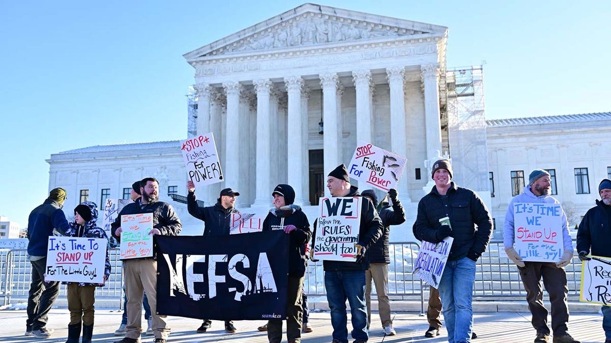 Members of the New England Fishermens Stewardship Association hold signs outside the Supreme Court on Wednesday.